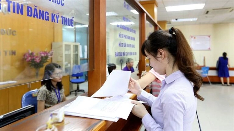 Một người cầm giấy đăng ký xe ô tô vừa sang tên